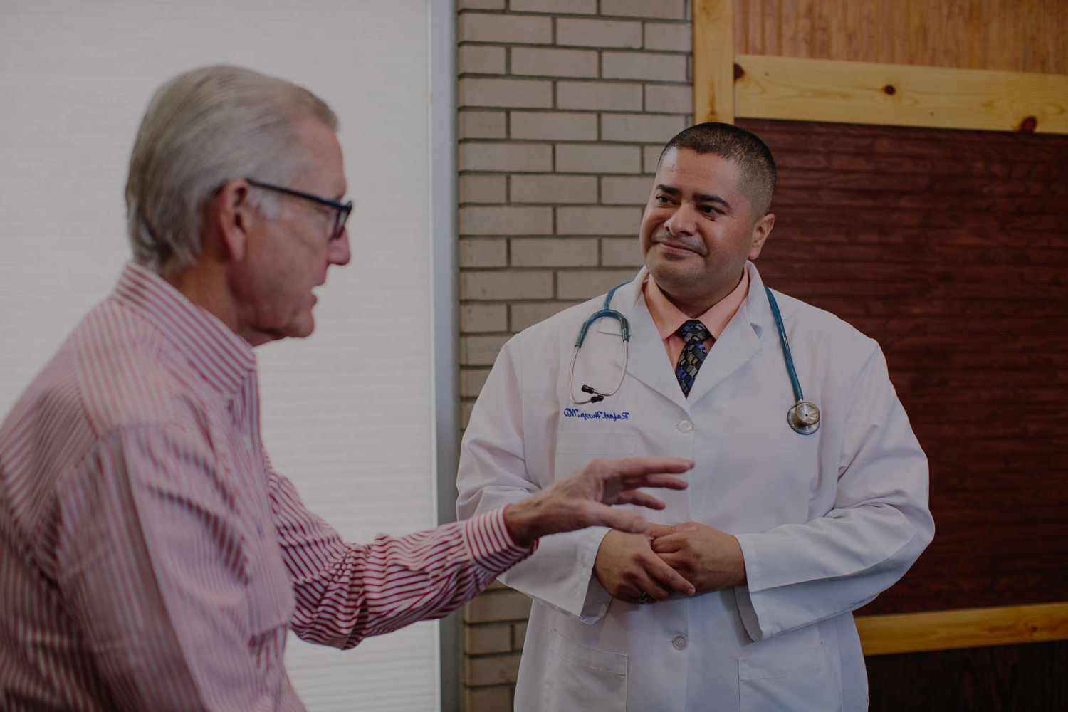 Dr. Huezo talking with a patient at Mint Health Clinics