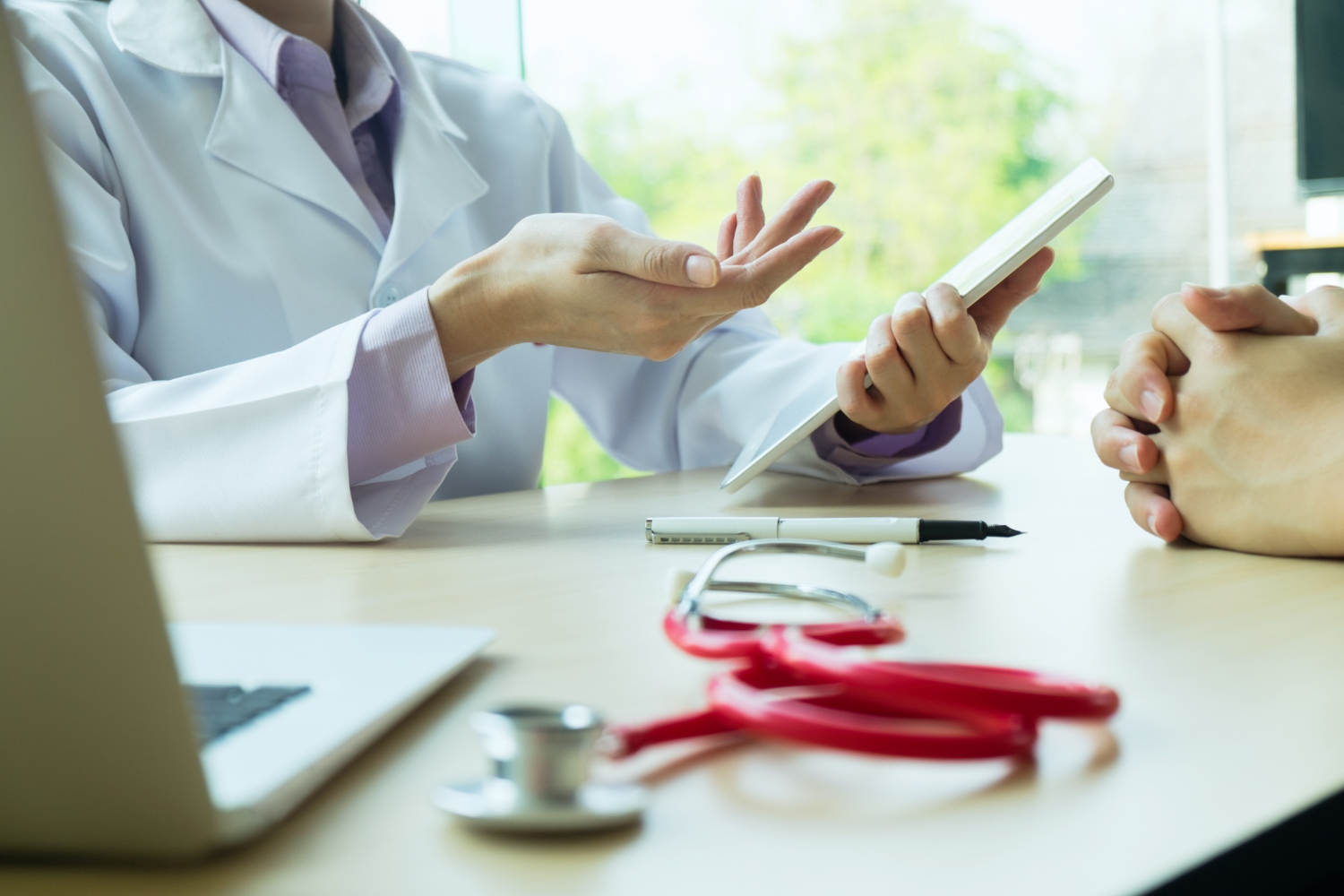 Doctor and patient reviewing a care plan together at a desk