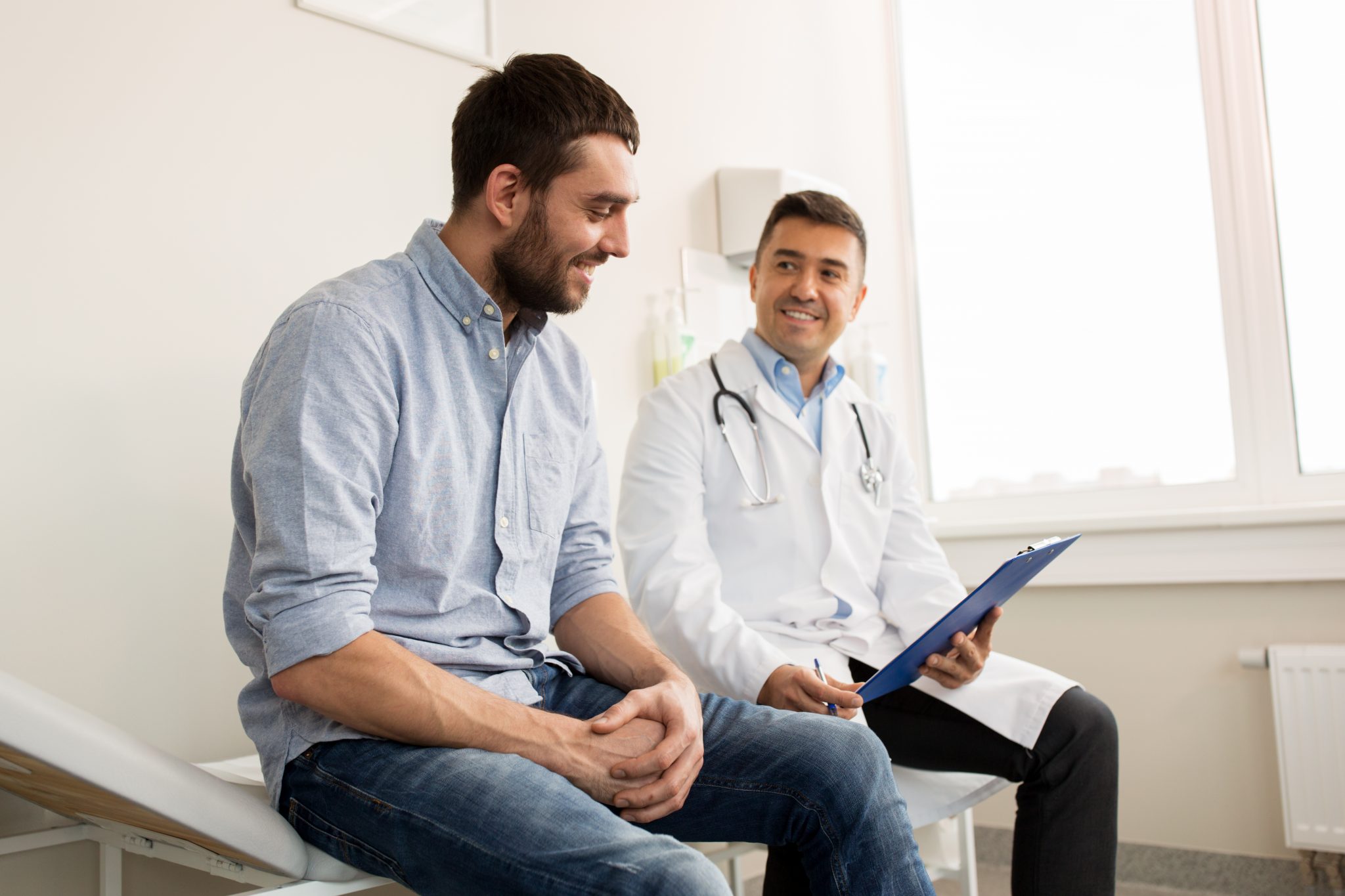 Doctor talking with a patient about their progress